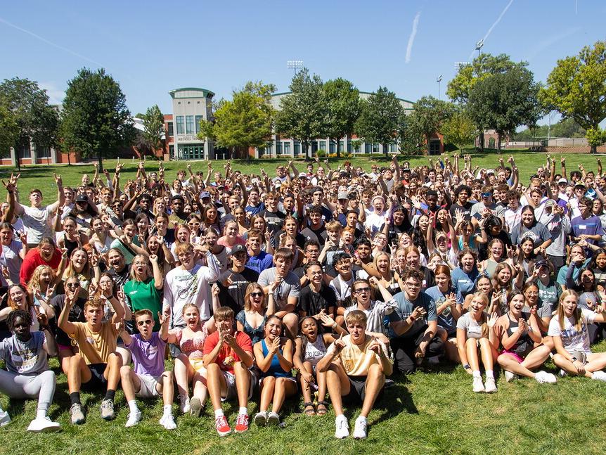 439 first-year students gather on Taylor Commons for a group photo on a bright sunny day.